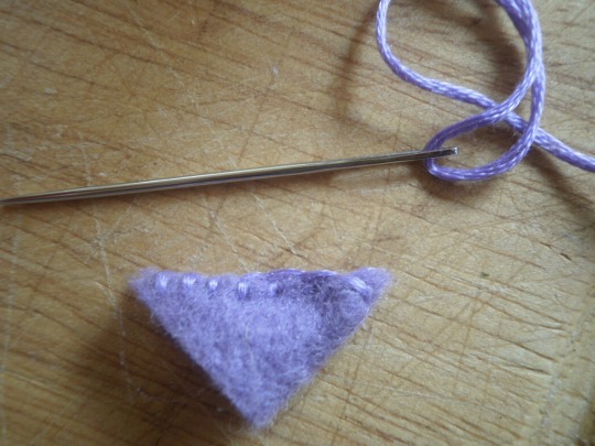 For the hat fold a triangle of felt in half and sew up one edge