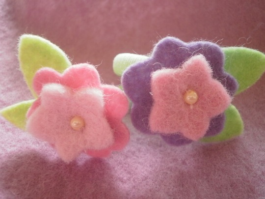 A pair of flower hair ties in complementing colours